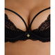 Close-up of a black lace bra with thin straps and a small gold charm at the center, shown on a model's torso.