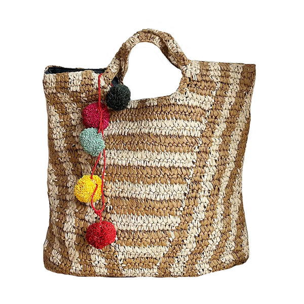 Woven tote bag with colorful pom-poms on a white background