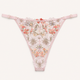 Light pink lace thong panties with floral embroidery and a scalloped edge, displayed flat against a light off-white background.