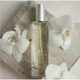 Perfume bottle labeled 'kai' with white flowers on a light background