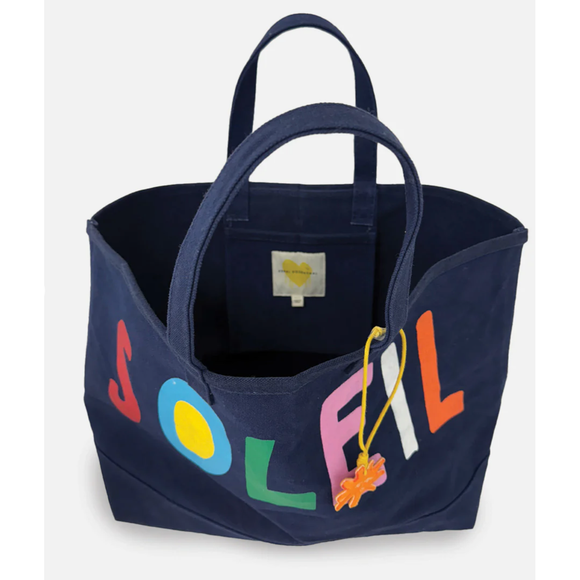 Navy blue tote bag with colorful letters and a heart tag on a white background