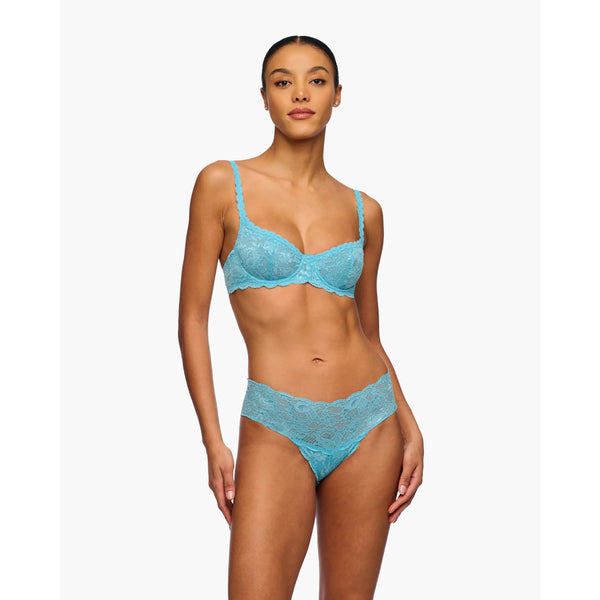 Woman wearing a blue lace lingerie set on a white background
