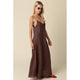 Woman wearing a brown slip dress against a beige background