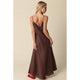 Woman wearing a brown slip dress with a beige background