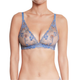 A woman wearing a light blue lace bra with floral embroidery and sheer mesh cups, shown from the neck to the lower torso against a plain white background.