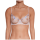 A woman wearing a light beige underwire bra with blue floral embroidery and sheer mesh cups, shown from the neck to the lower torso against a plain white background.