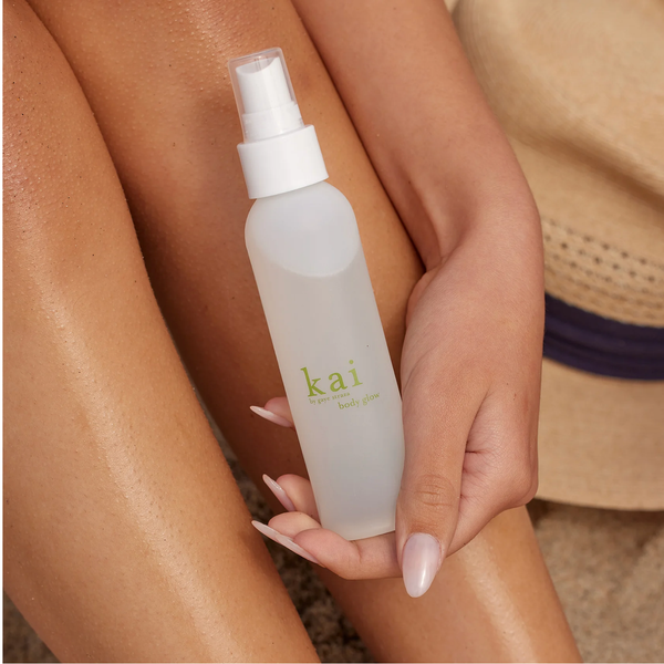 Person holding a 'kai' bottle of body mist on their leg