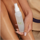 Person holding a 'kai' bottle of body mist on their leg