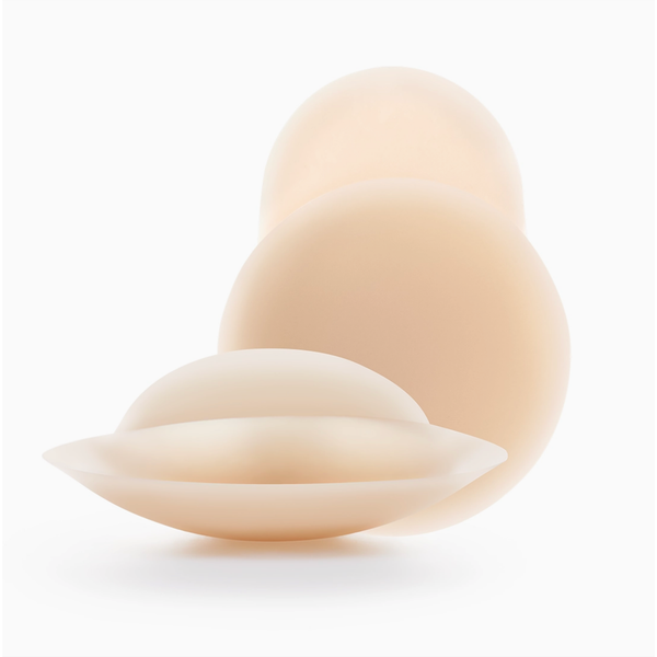 Three silicone breast implant silhouettes in varying sizes, arranged in a cascading stack on a clean white background.
