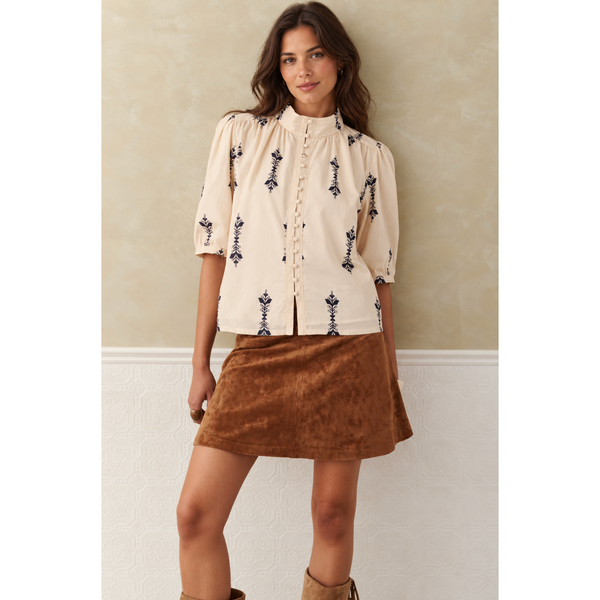 Melissa Nepton Anna Blouse in Cream/Navy, front view on model showing botanical motifs, stand collar, and puff sleeves