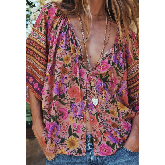 Person wearing a colorful floral kimono with a blurred background