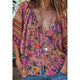Person wearing a colorful floral kimono with a blurred background