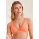 Woman wearing an orange bralette with lace details on a beige background
