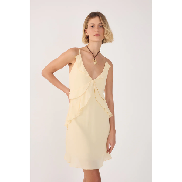Woman wearing a light yellow dress with a white background