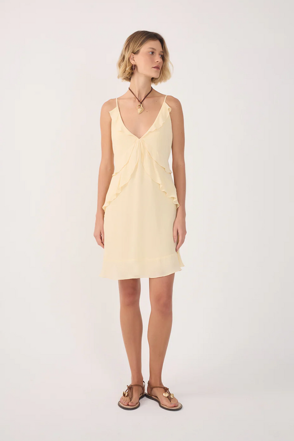 Woman wearing a light yellow dress on a white background