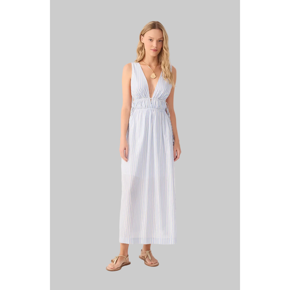 Woman wearing a white striped dress on a grey background