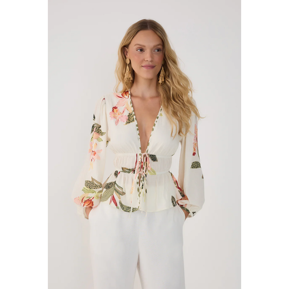Woman wearing a floral blouse with a white background