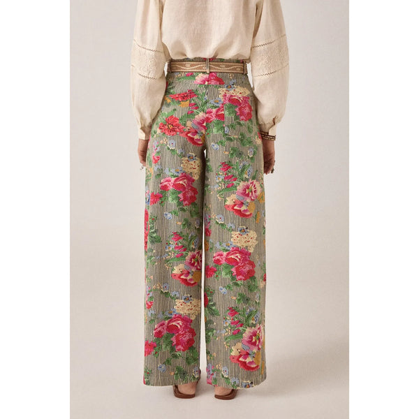 Floral patterned pants worn by a person on a plain background