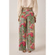 Floral patterned pants worn by a person on a plain background
