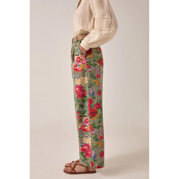 Person wearing floral pants with a neutral background