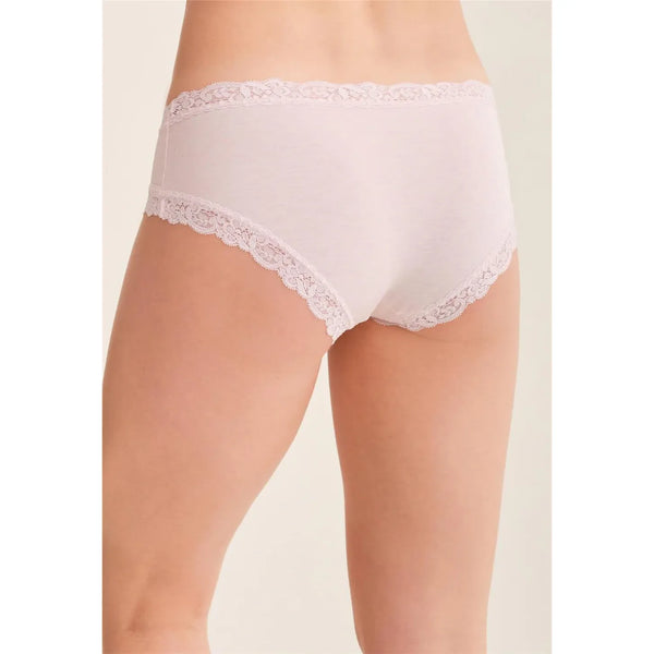 White lace-trimmed underwear on a beige background