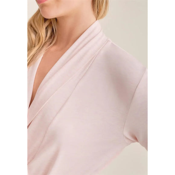 Close-up of a light pink garment with a blurred background