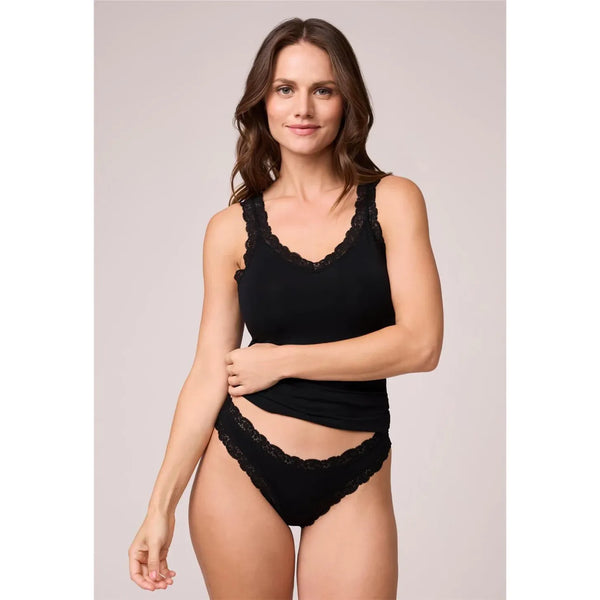 Woman wearing a black lace lingerie set against a plain background
