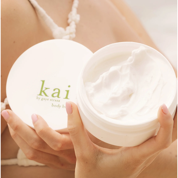 open container of 'kai' body butter held by a person.