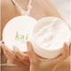 open container of 'kai' body butter held by a person.