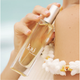 Person holding a 'kai' perfume bottle with a blurred background