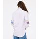 Person wearing a white striped shirt with colorful designs on the sleeves against a white background