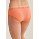 Orange lace underwear on a neutral background