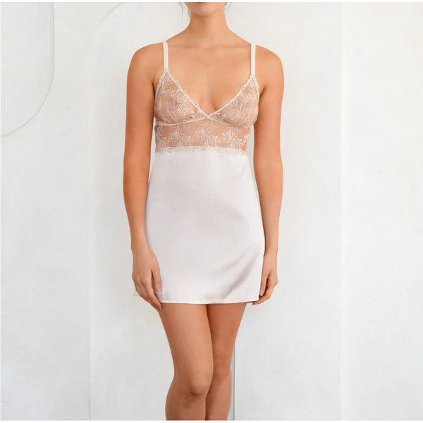 White slip dress with lace detailing on a white background