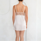 White satin nightgown with lace details on a white background