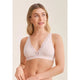 Woman wearing a light pink bralette with lace details on a beige background